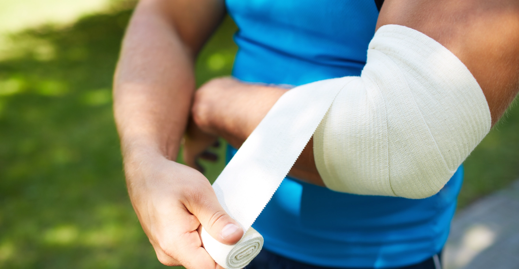 person bandaging their burn injury