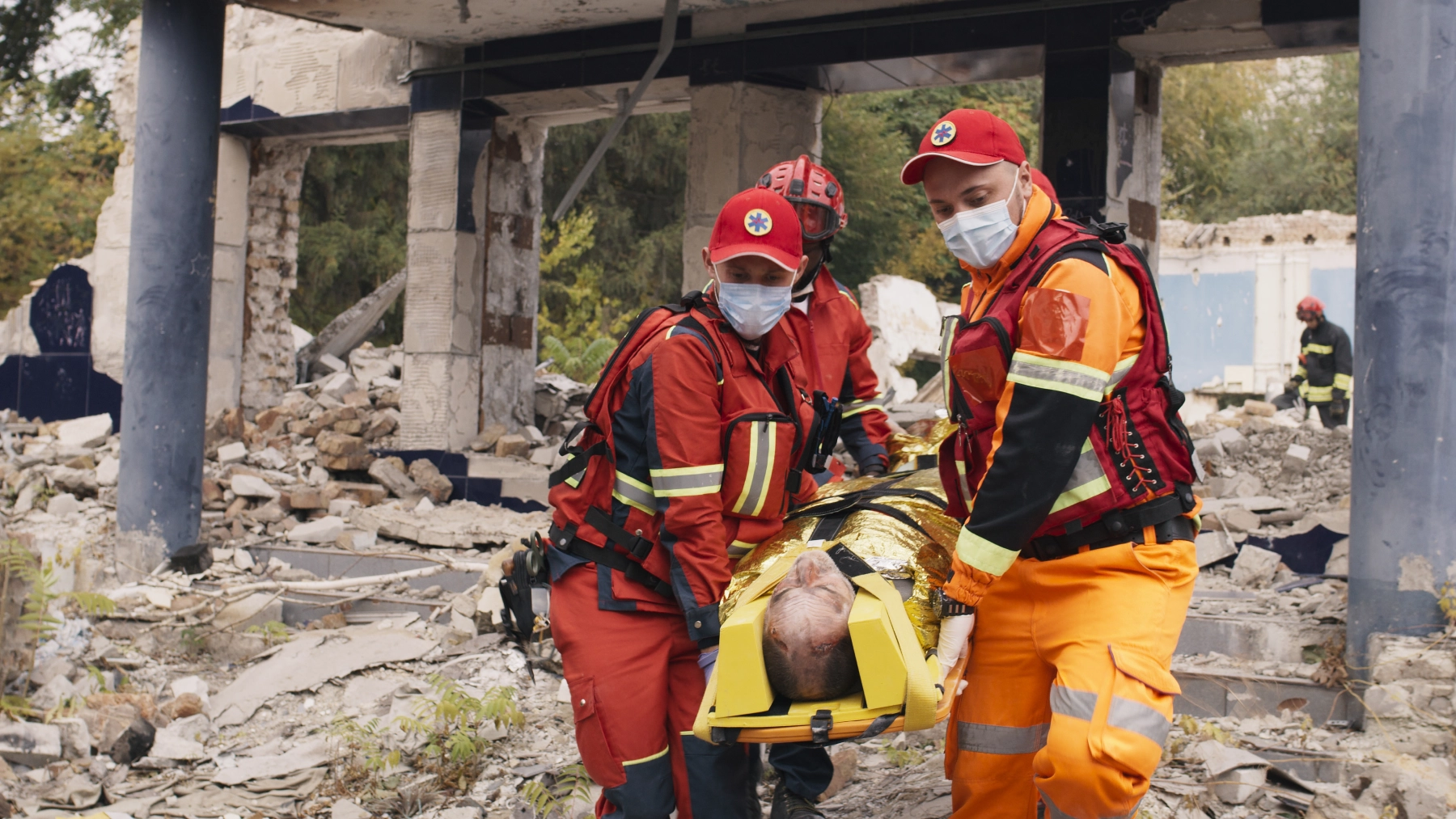 3 paramedics carrying a catastrophic injury victim
